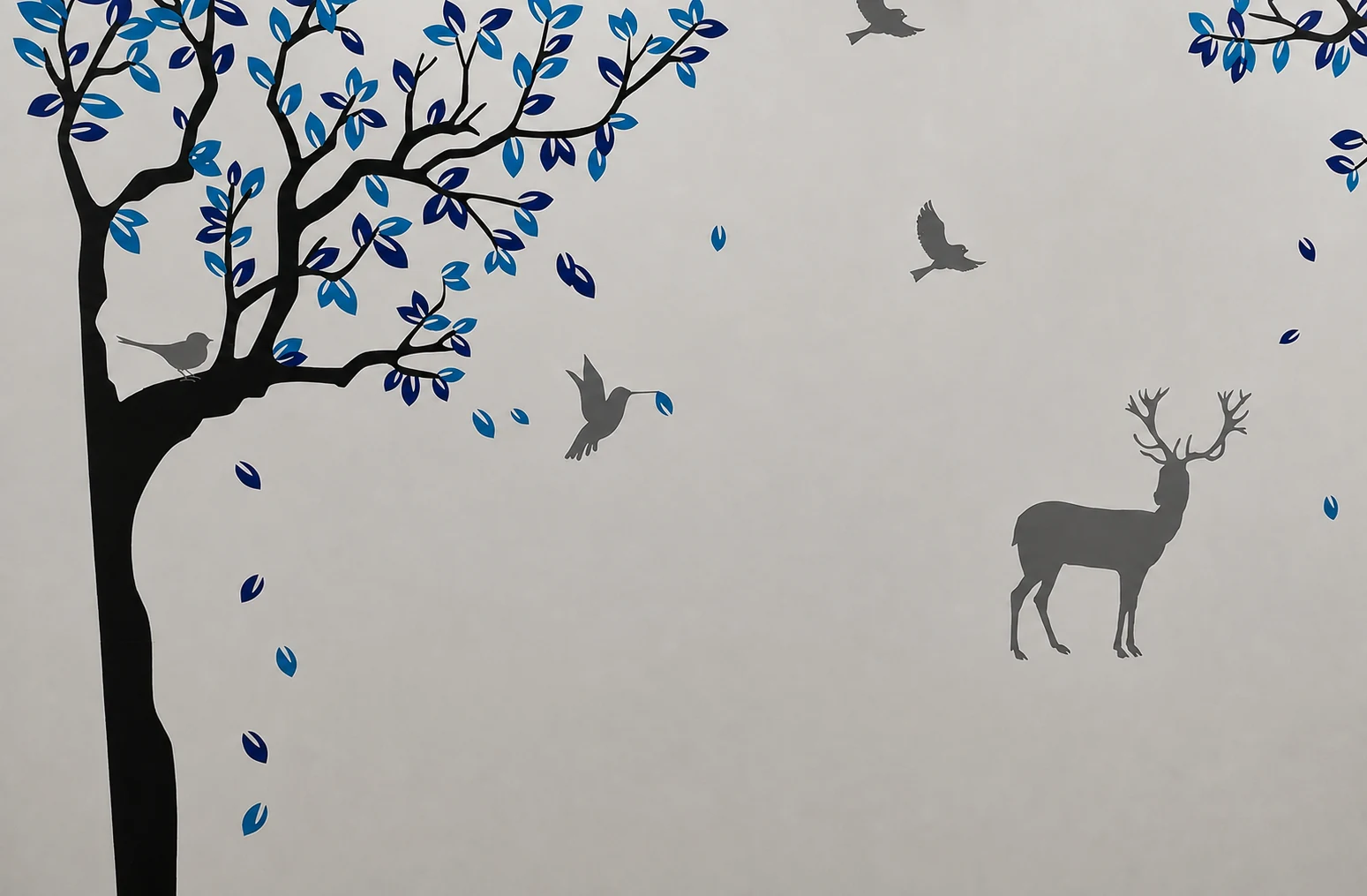 Blue tree, birds and deer wall artwork at Kidney Care Clinic