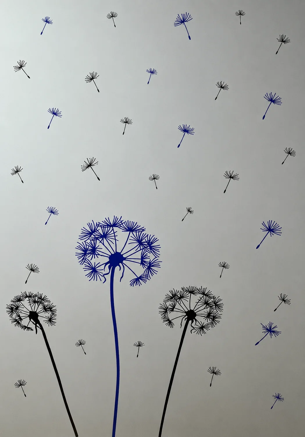 Blue and black dandelion wall artwork at Kidney Care Clinic