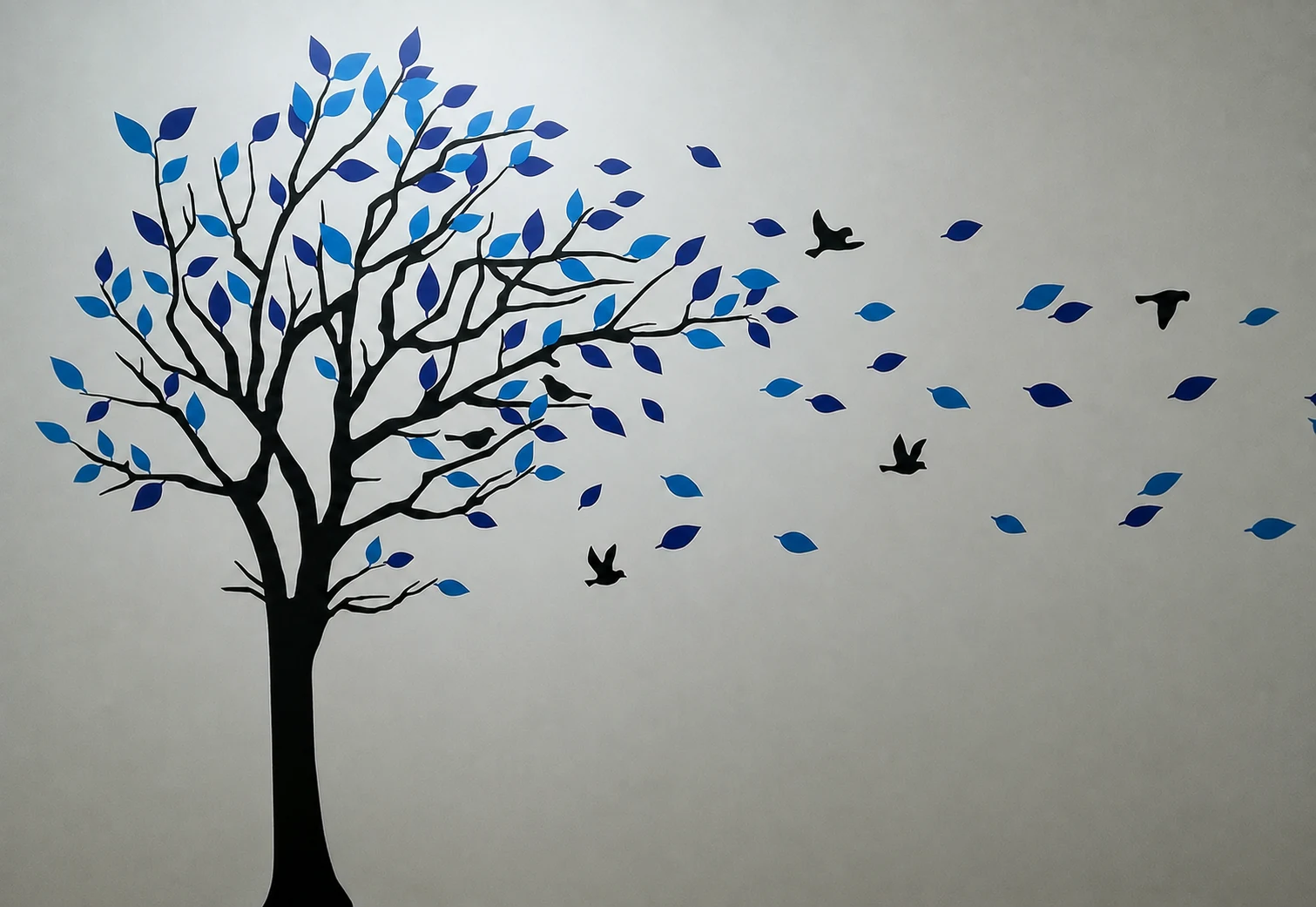 Blue tree and birds wall artwork at Kidney Care Clinic